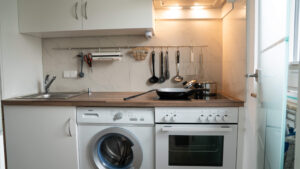Küche mit Herd, Ofen und Waschmaschine.